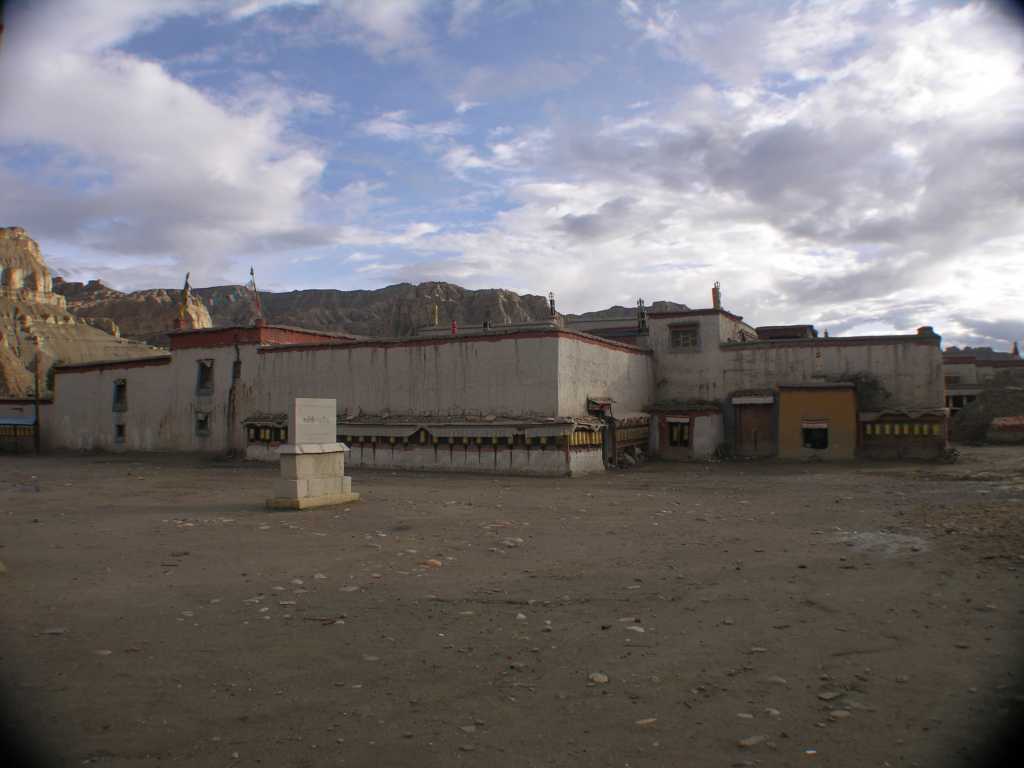 Tibet Guge 03 Tholing 01 Red Temple Buildings In Front Tholing monastery was built in the eleventh century, during the reign of Yeshe-O, the King of Guge, Western Tibet. It proved a refuge for numerous scholars and translators. It was here that Atisha met Lotsawa Rinchen Sangpo and also where he wrote his seminal text, Lamp of the Path, which has remained an inspiration for generations up to the present day. The monastery, said to have been modeled after Samye in Central Tibet, is noted today for the exquisite quality of the murals that cover its walls. These paintings delightfully express the vigour of the transmission of Buddhism from India to Tibet and the dynamic mingling of cultures. Even after so many centuries, which have seen the abandonment and ruin of the buildings that house them, they retain a freshness that is a joy to see. � Dalai Lama, Foreword: Ewald Hein / G�nther Boelmann: Tibet � Der Wei�e Tempel von Tholing.